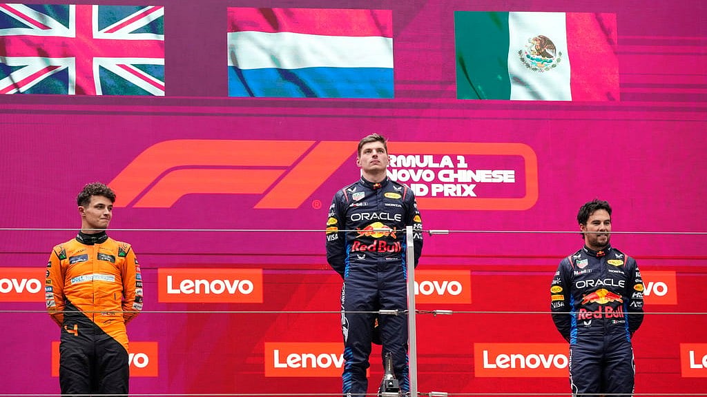 (AP Photo)
 : Winner Red Bull driver Max Verstappen of the Netherlands, center, listens to his national anthem flanked on the podium with second placed McLaren driver Lando Norris of Britain, left, and third Red Bull driver Sergio Perez of Mexico after the Chinese Formula One Grand Prix at the Shanghai International Circuit, Shanghai, China, Sunday, April 21, 2024. 

